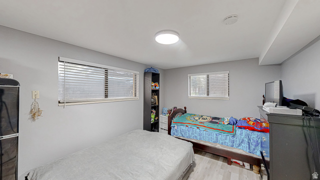 630 1100 West Provo, UT 84601 - Photo 26 of 64 Room featuring two windows with horizontal blinds, light-toned wood-finish flooring, and a flush-mount ceiling light fixture
