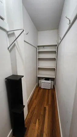 a view of walk in closet with empty racks