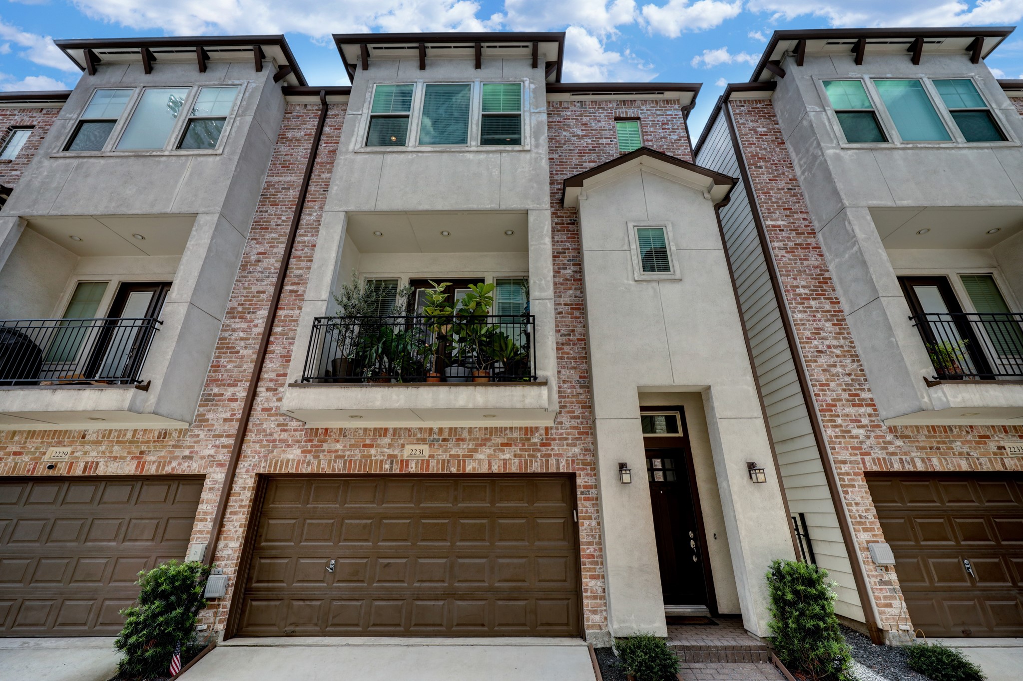 a front view of a house with a garden