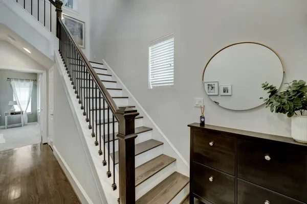 a view of entryway and hall with wooden floor