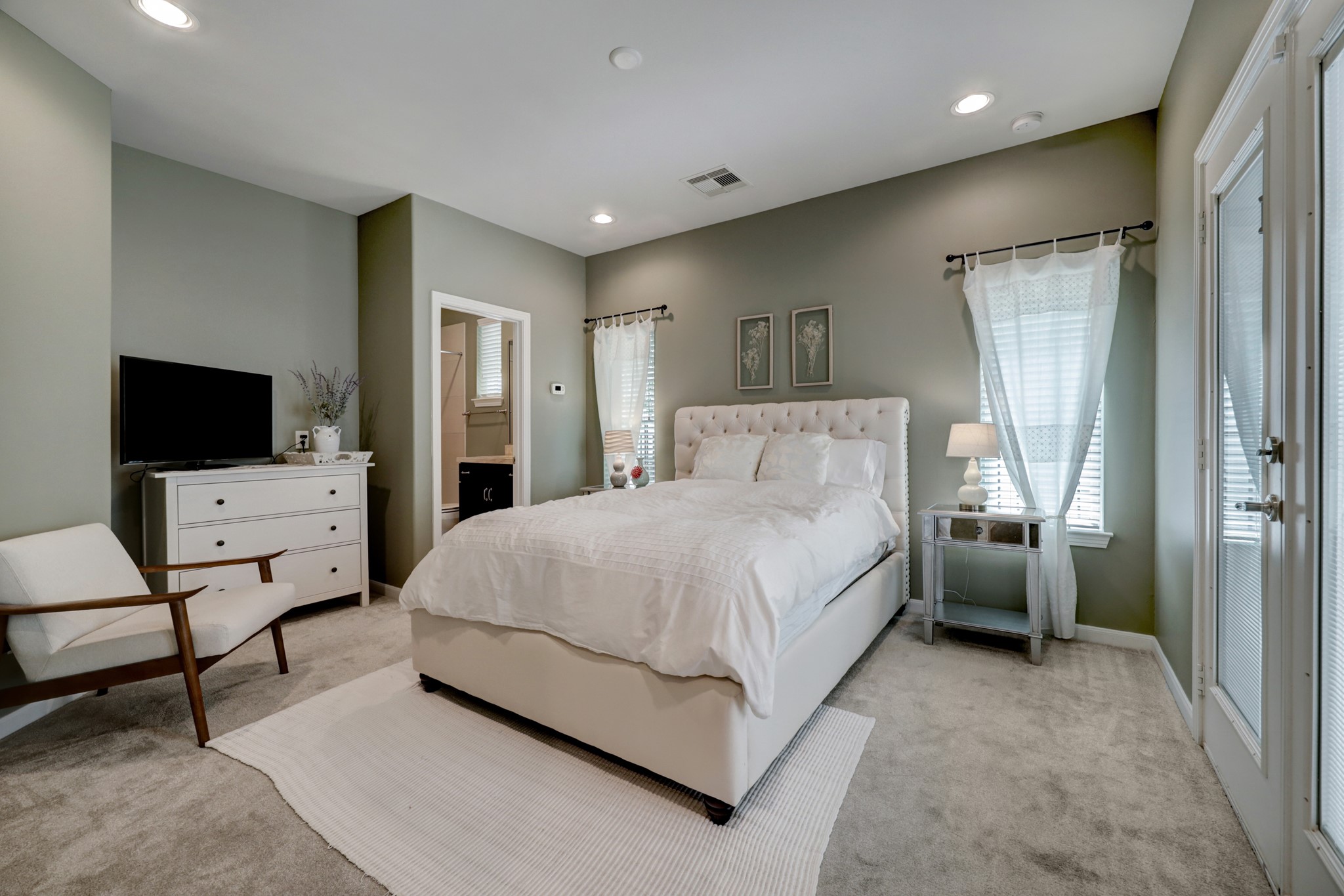 2231 Chenevert Street Houston, TX 77003 - Photo 6 of 26 a spacious bedroom with a bed and a flat screen tv