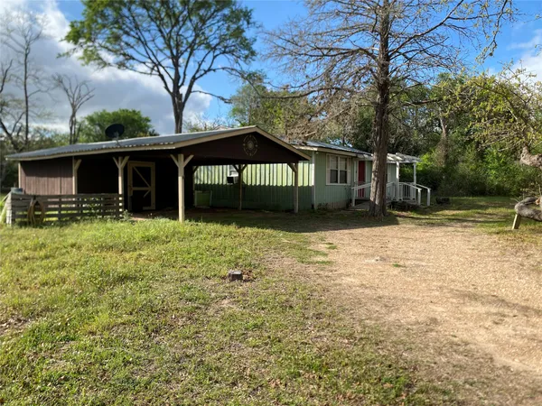 a front view of house with yard and trees