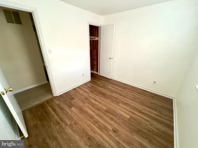 an empty room with wooden floor
