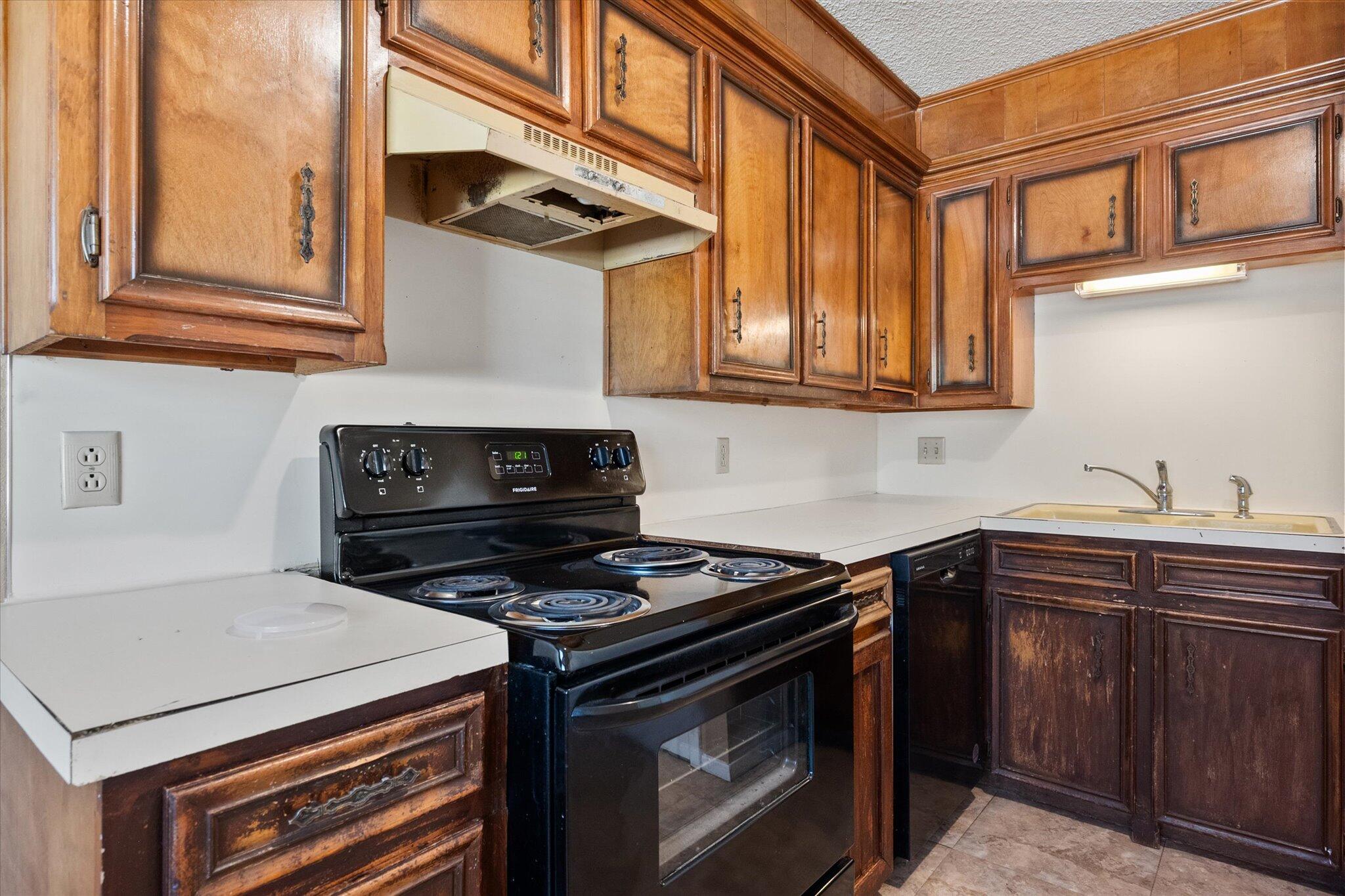 6407 28th Street Lubbock, TX 79407 - Photo 11 of 23 a kitchen with stainless steel appliances granite countertop a stove and a microwave
