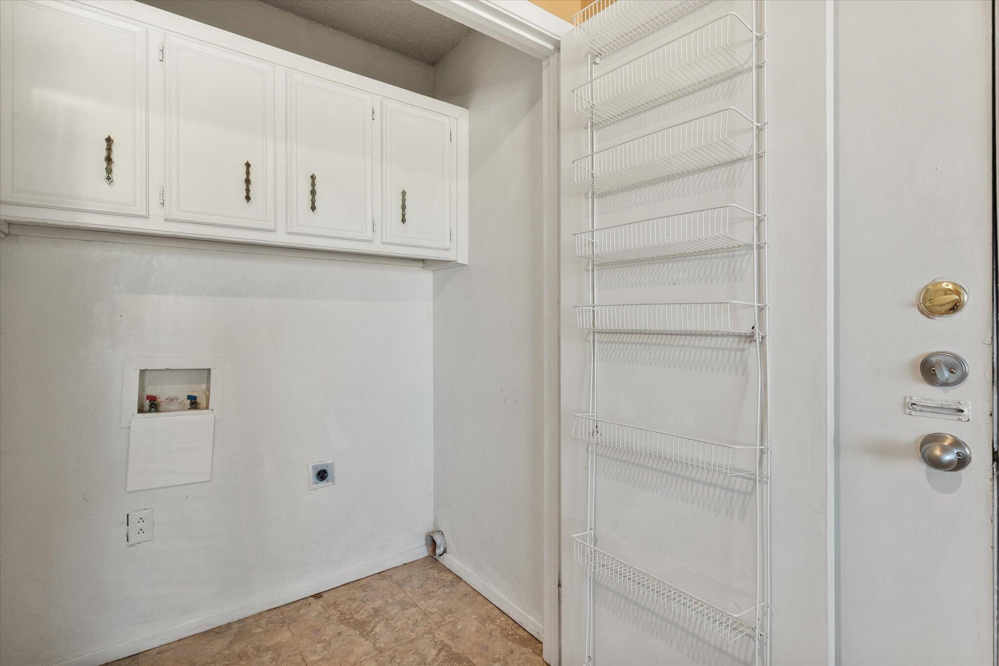 6407 28th Street Lubbock, TX 79407 - Photo 13 of 23 a view of cabinets and utility room