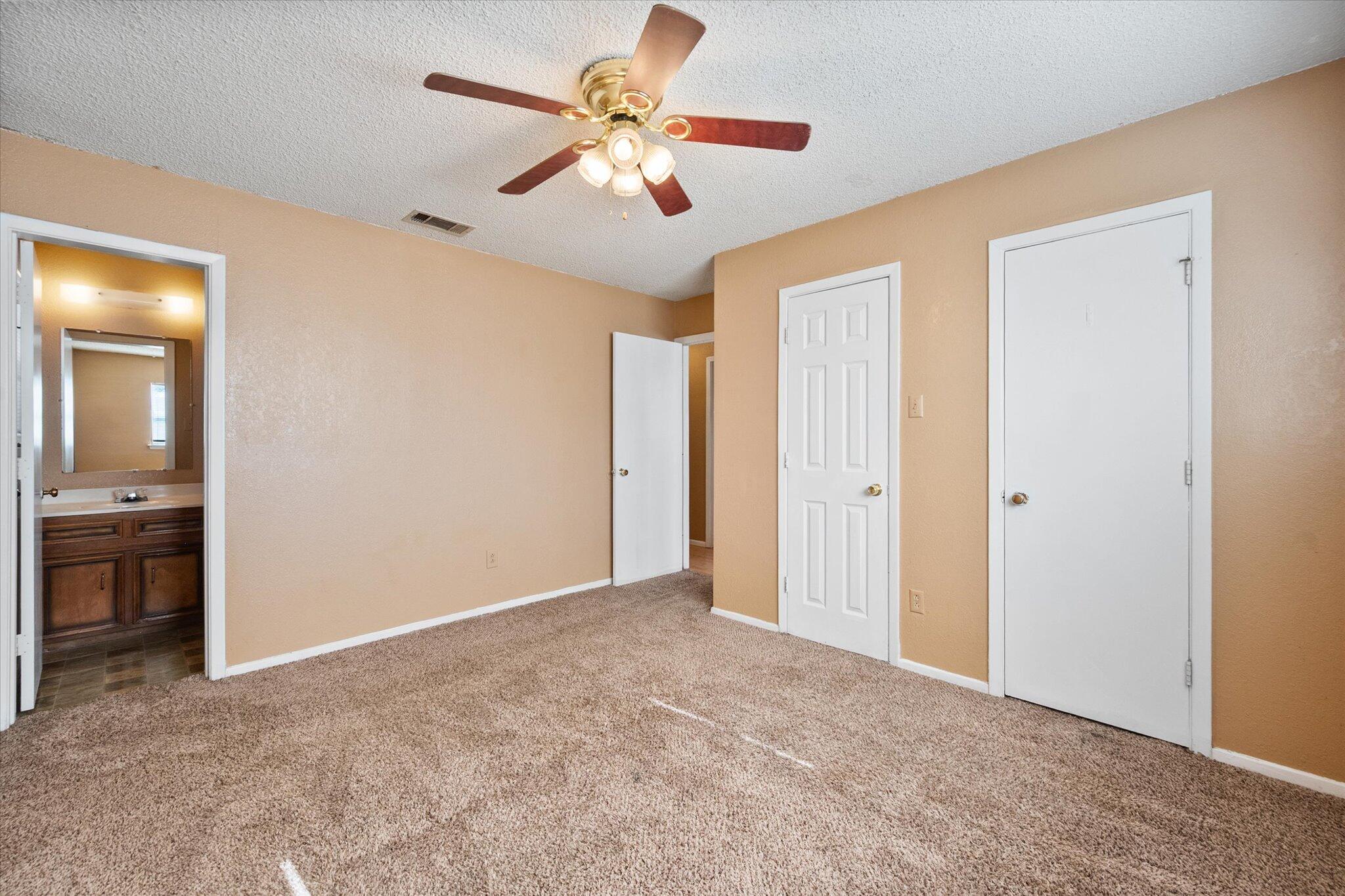 6407 28th Street Lubbock, TX 79407 - Photo 14 of 23 an empty room with closet and a ceiling fan
