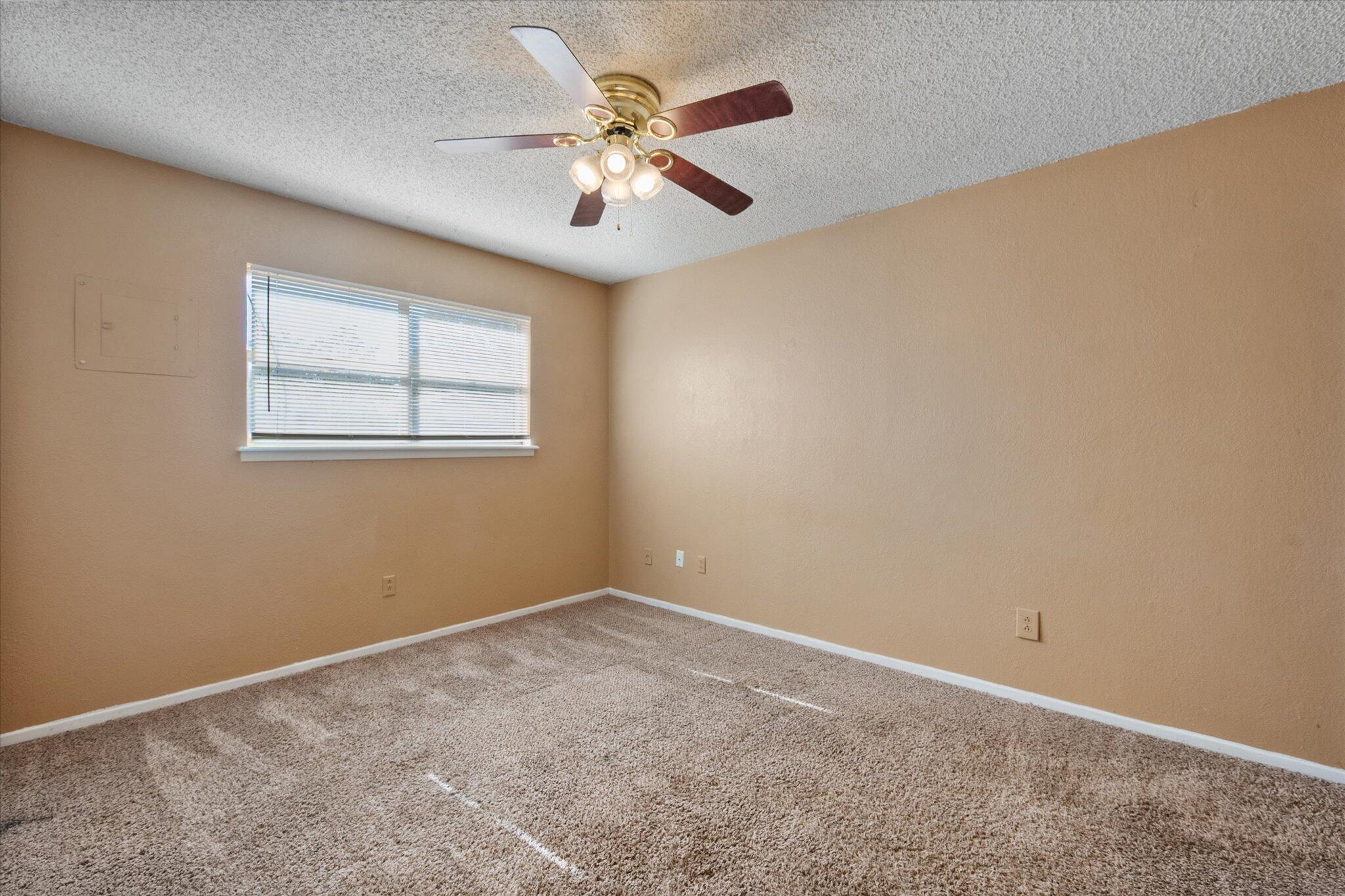 6407 28th Street Lubbock, TX 79407 - Photo 15 of 23 an empty room with a window and a fan
