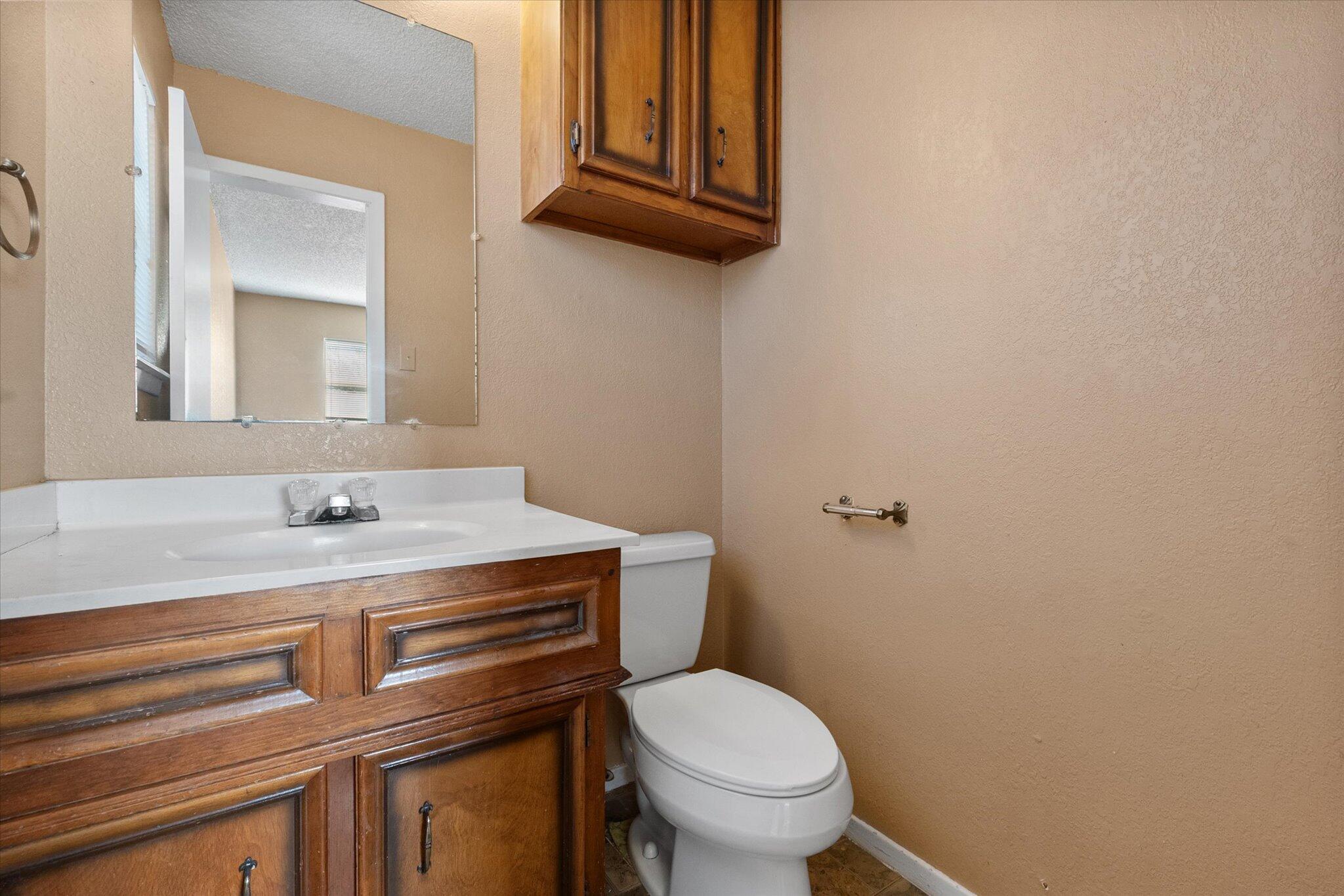 6407 28th Street Lubbock, TX 79407 - Photo 16 of 23 a bathroom with a sink and a toilet