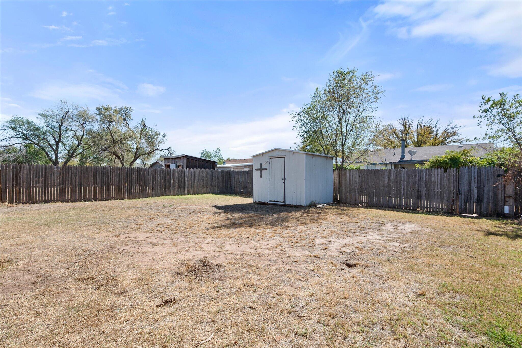 6407 28th Street Lubbock, TX 79407 - Photo 20 of 23 a view of a backyard with wooden fence