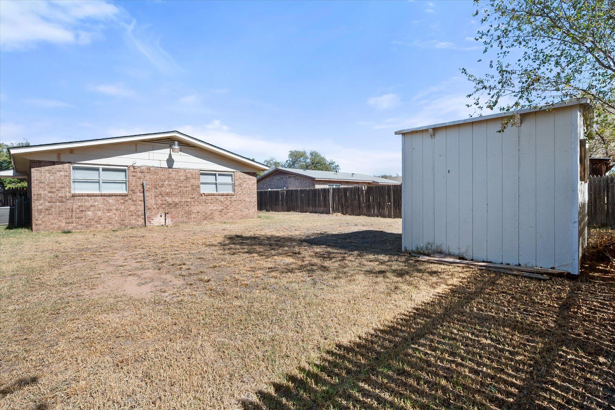 6407 28th Street Lubbock, TX 79407 - Photo 21 of 23 a view of a house with a backyard