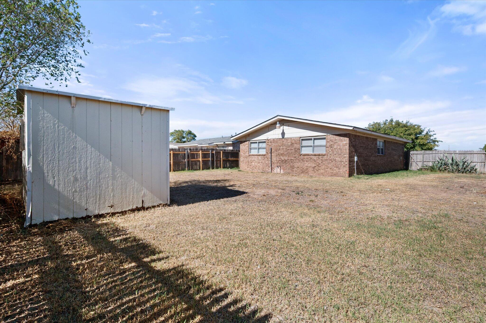 6407 28th Street Lubbock, TX 79407 - Photo 23 of 23 a view of a house with backyard and trees