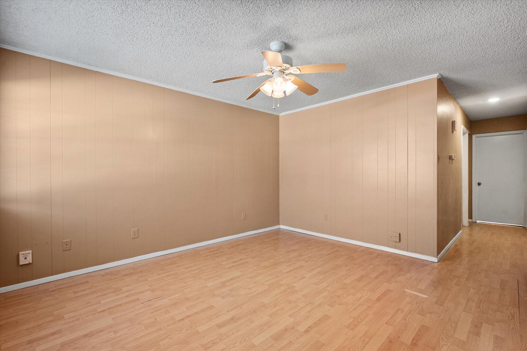 6407 28th Street Lubbock, TX 79407 - Photo 4 of 23 a view of an empty room with wooden floor