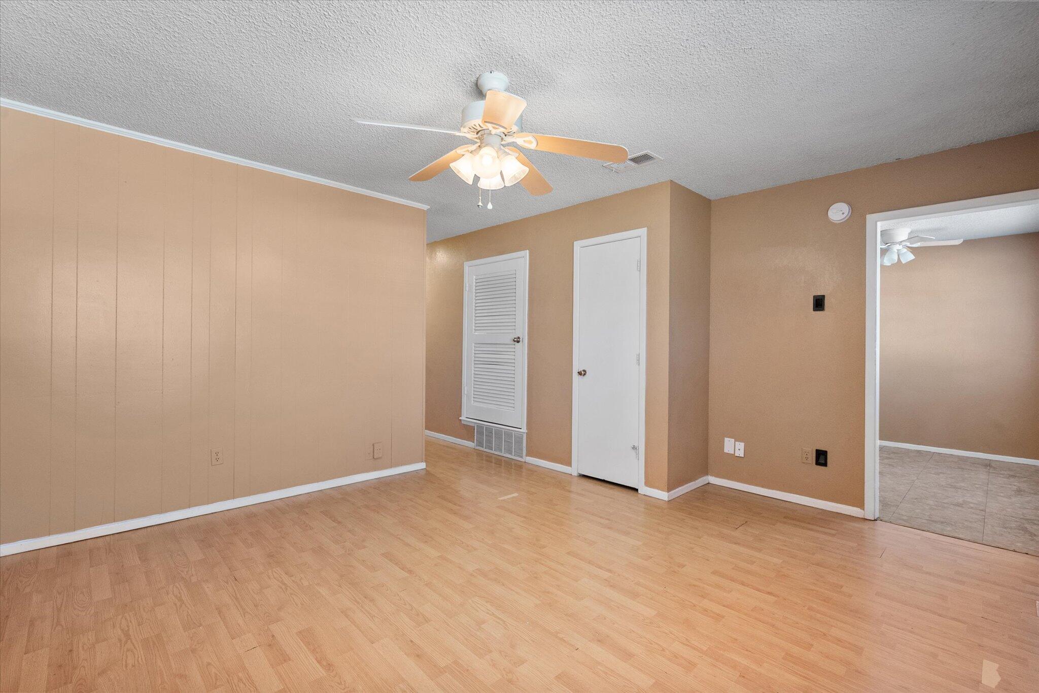 6407 28th Street Lubbock, TX 79407 - Photo 5 of 23 an empty room with closet and a chandelier fan