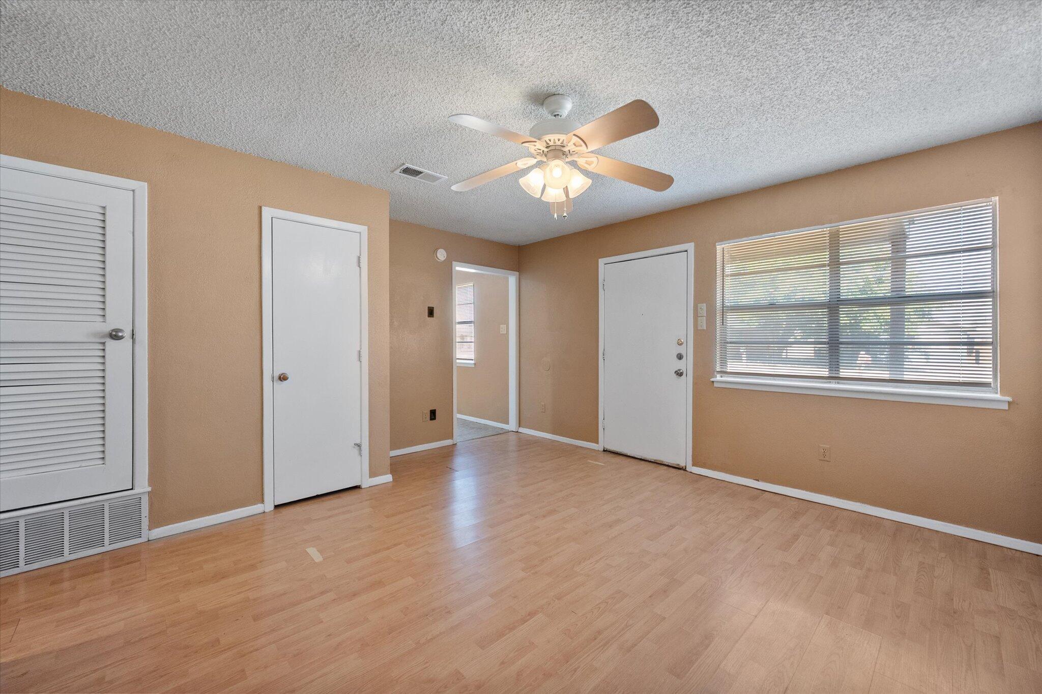 6407 28th Street Lubbock, TX 79407 - Photo 6 of 23 an empty room with windows and fan