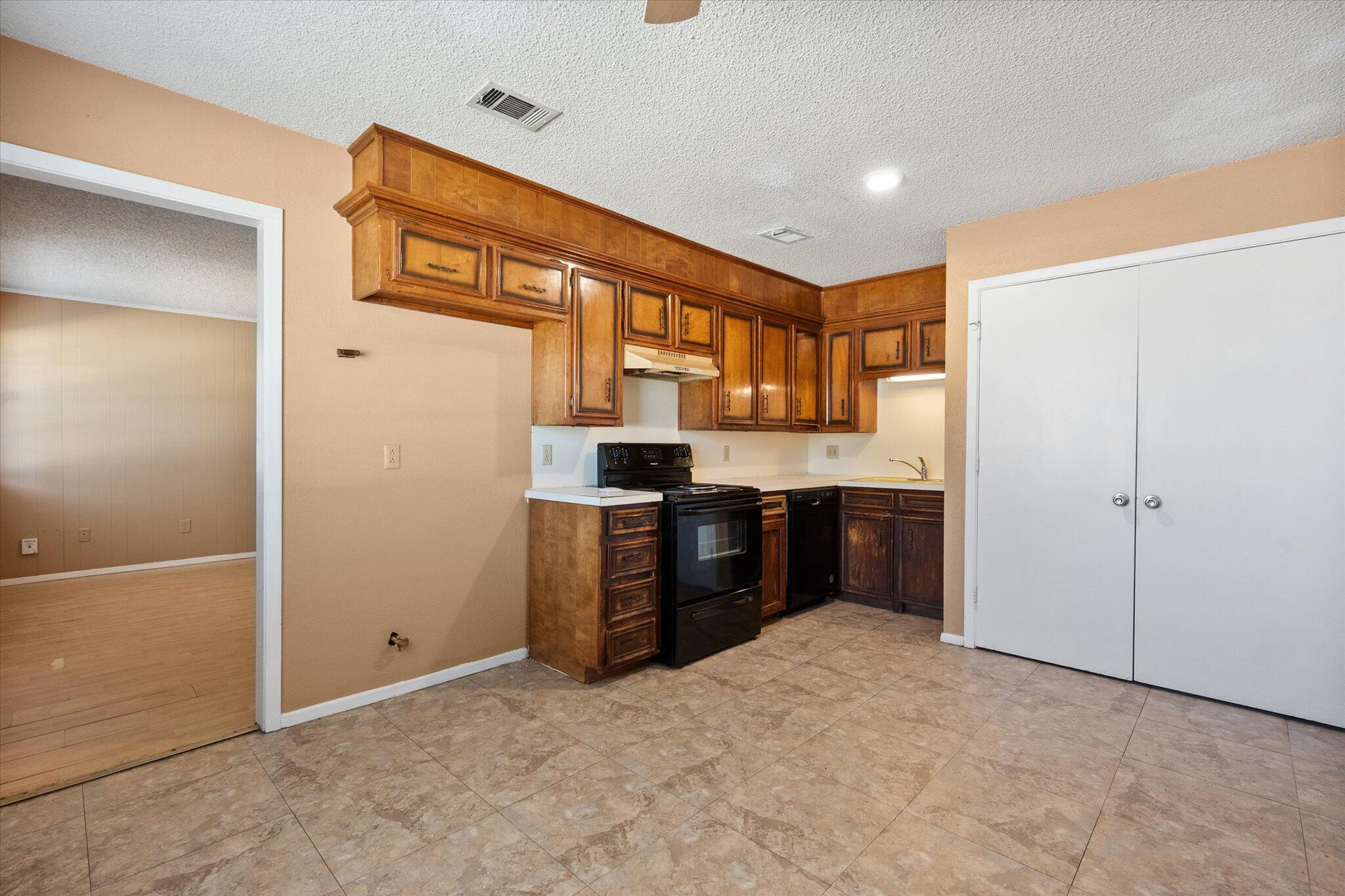 6407 28th Street Lubbock, TX 79407 - Photo 9 of 23 a kitchen with a refrigerator and a sink