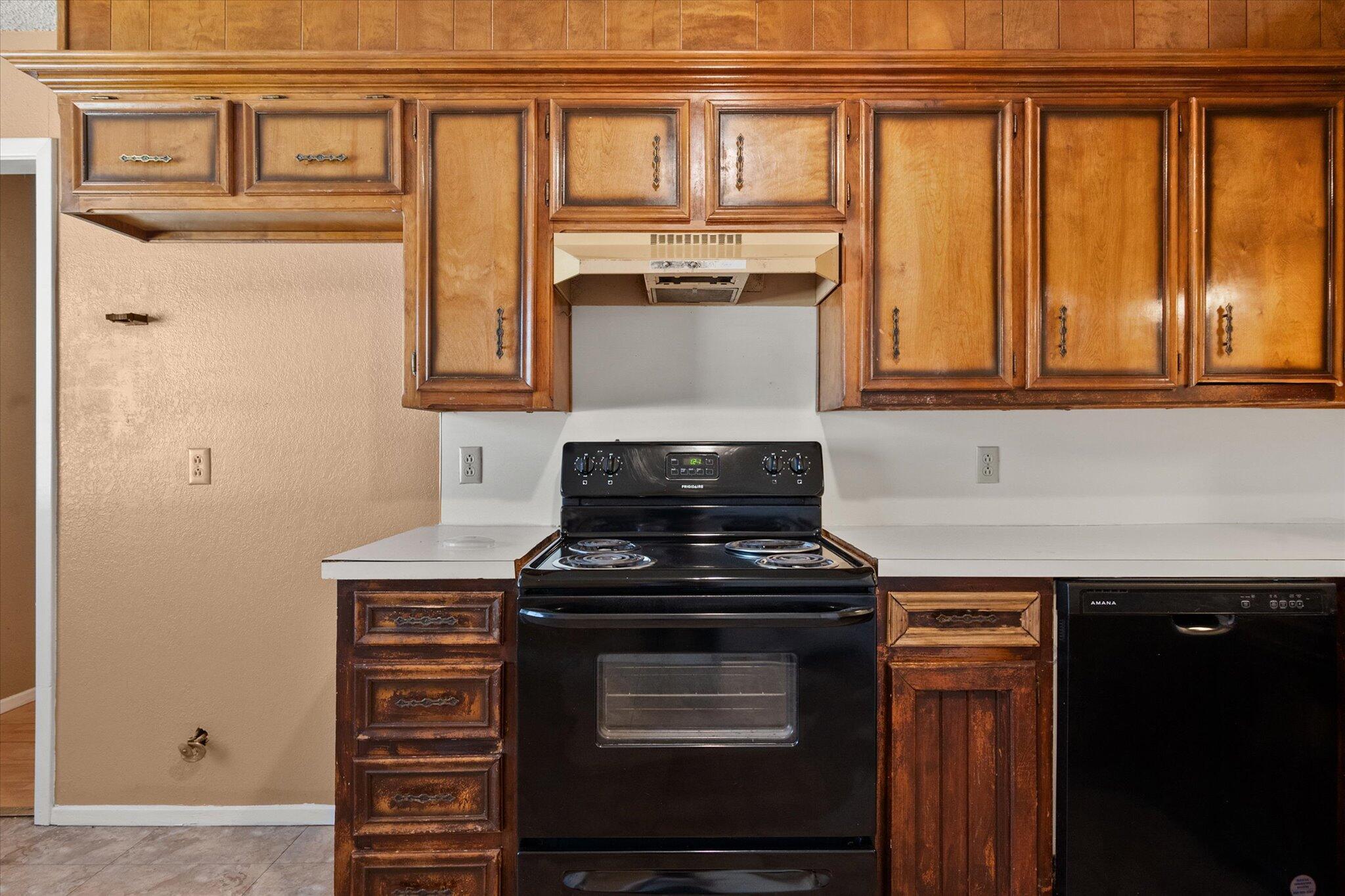 6407 28th Street Lubbock, TX 79407 - Photo 10 of 23 a kitchen with granite countertop a stove top oven
