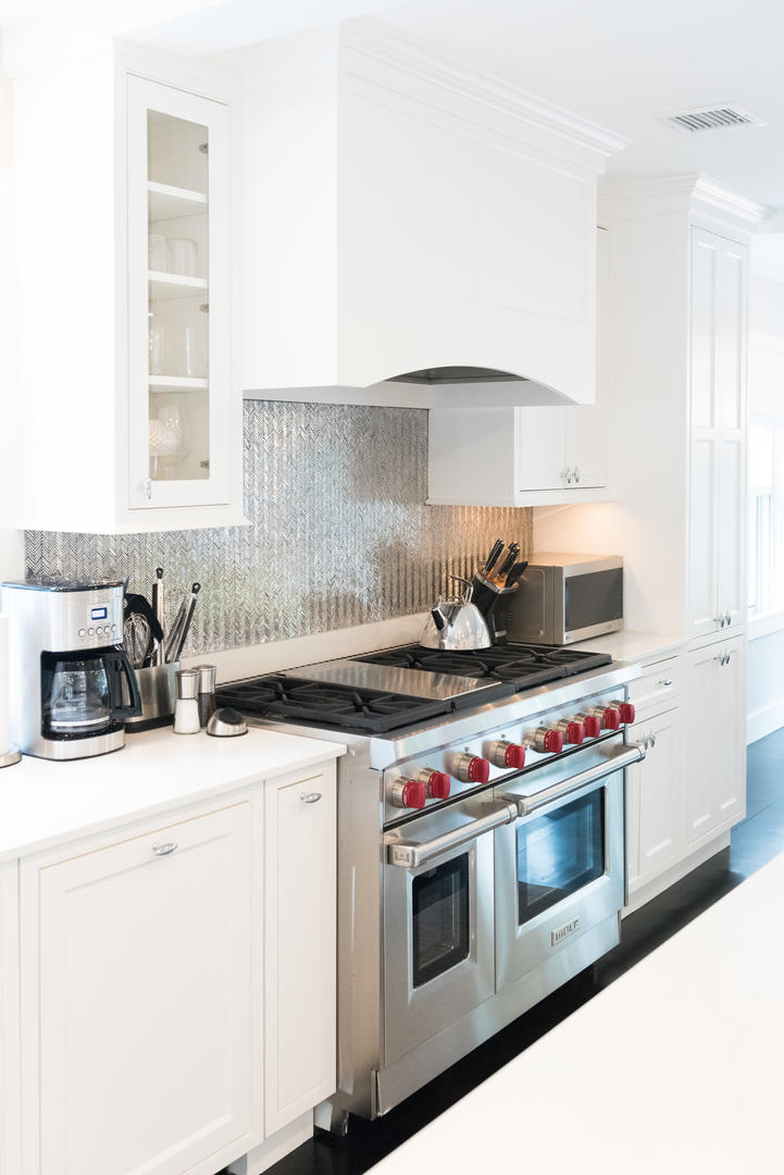 59 Orange Street Nantucket, MA 02554 - Photo 16 of 42 a kitchen with stove a sink and a microwave