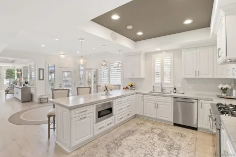 a large white kitchen with a large window