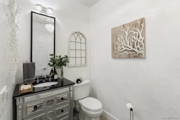 a bathroom with a toilet a sink and mirror