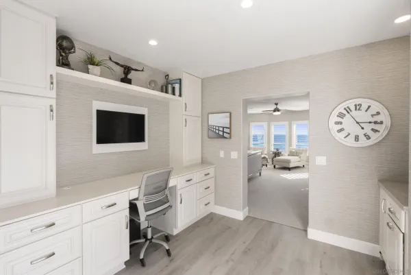 a living room with furniture a clock on wall and a table
