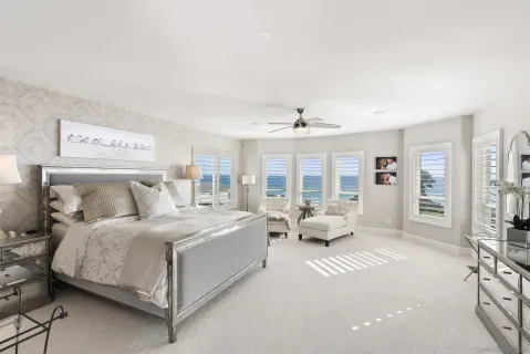 a spacious bedroom with a bed and glass door
