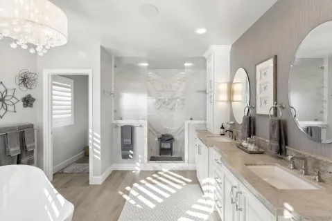 a spacious bathroom with a double vanity sink a mirror and a shower