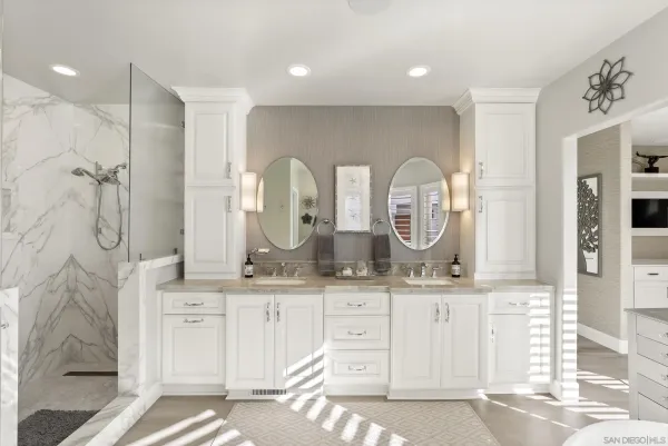 a bathroom with a granite countertop sink a mirror and a shower
