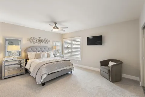 a spacious bedroom with a bed and a television