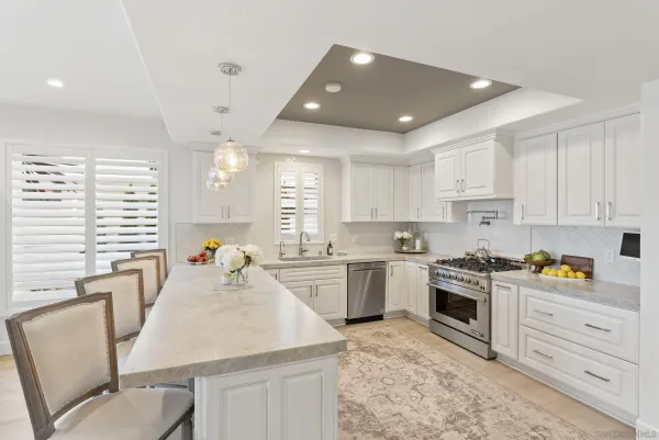 a kitchen with sink stove top oven and cabinets