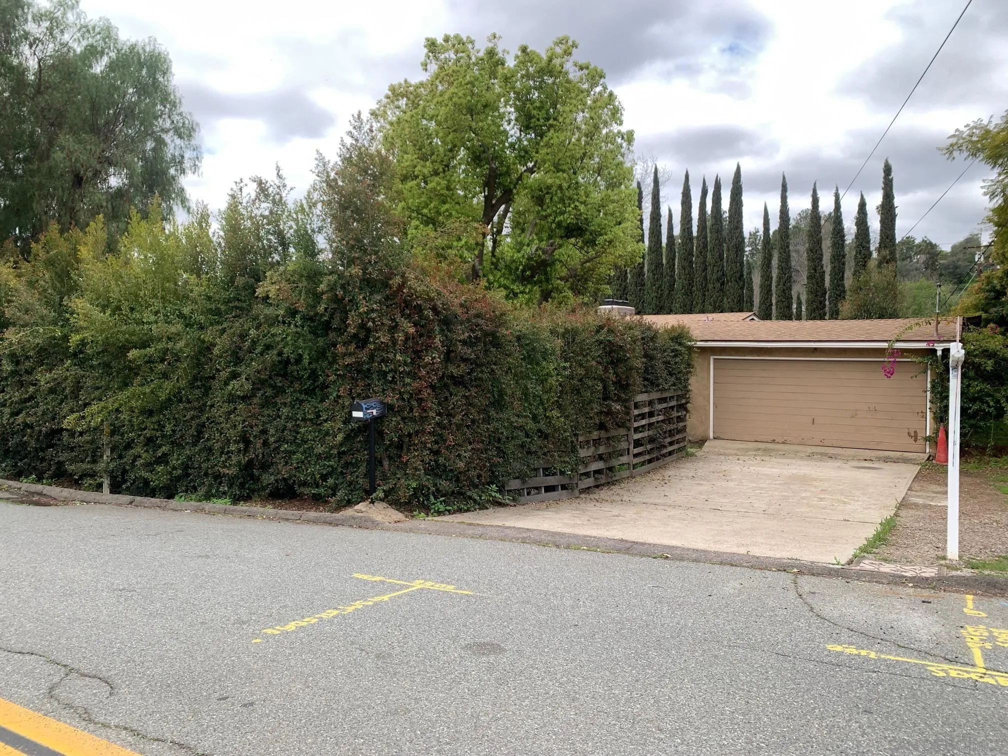a view of a garage with a tree