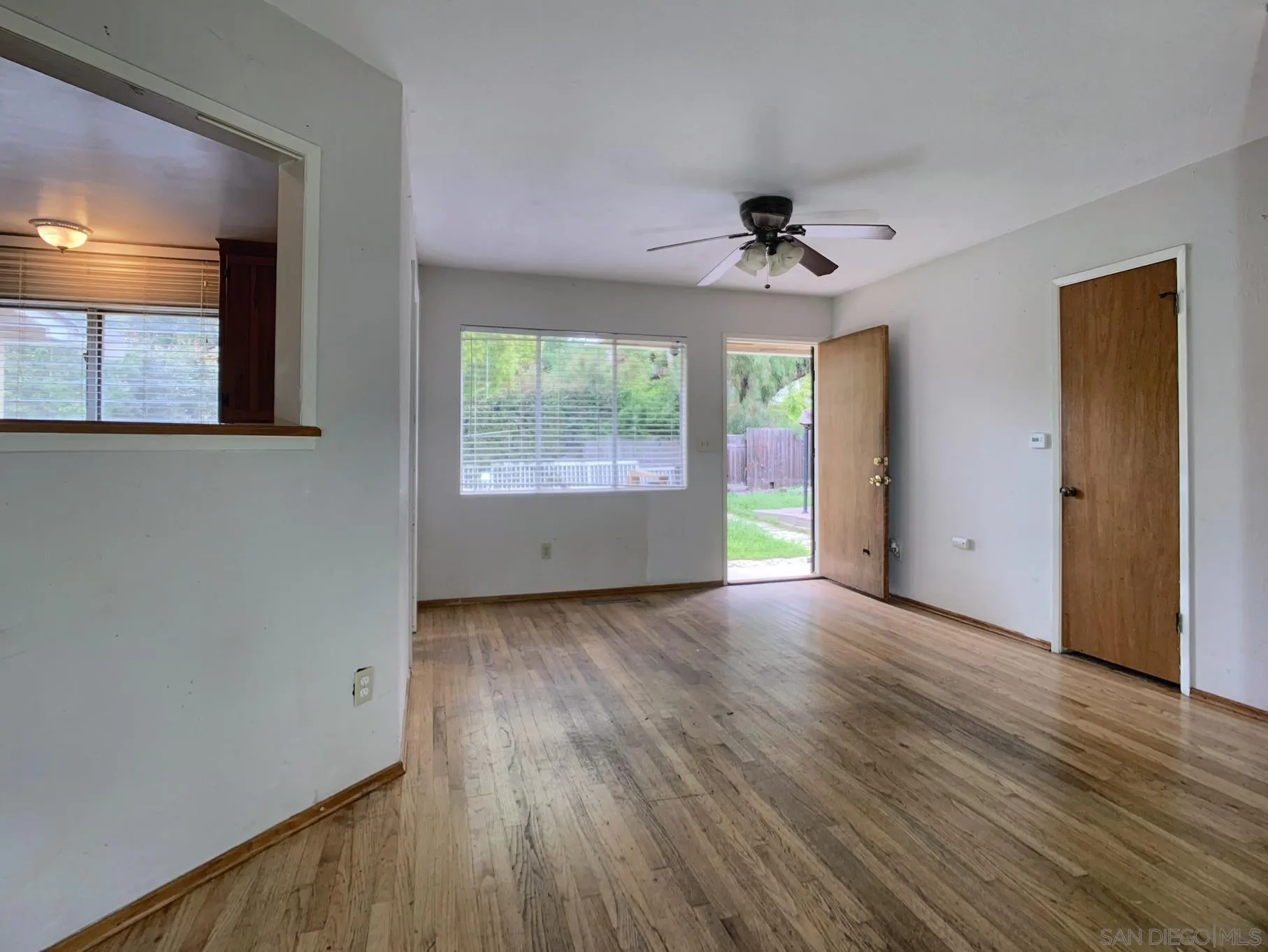 4240 Camino Paz La Mesa, CA 91941 - Photo 13 of 33 an empty room with wooden floor and windows