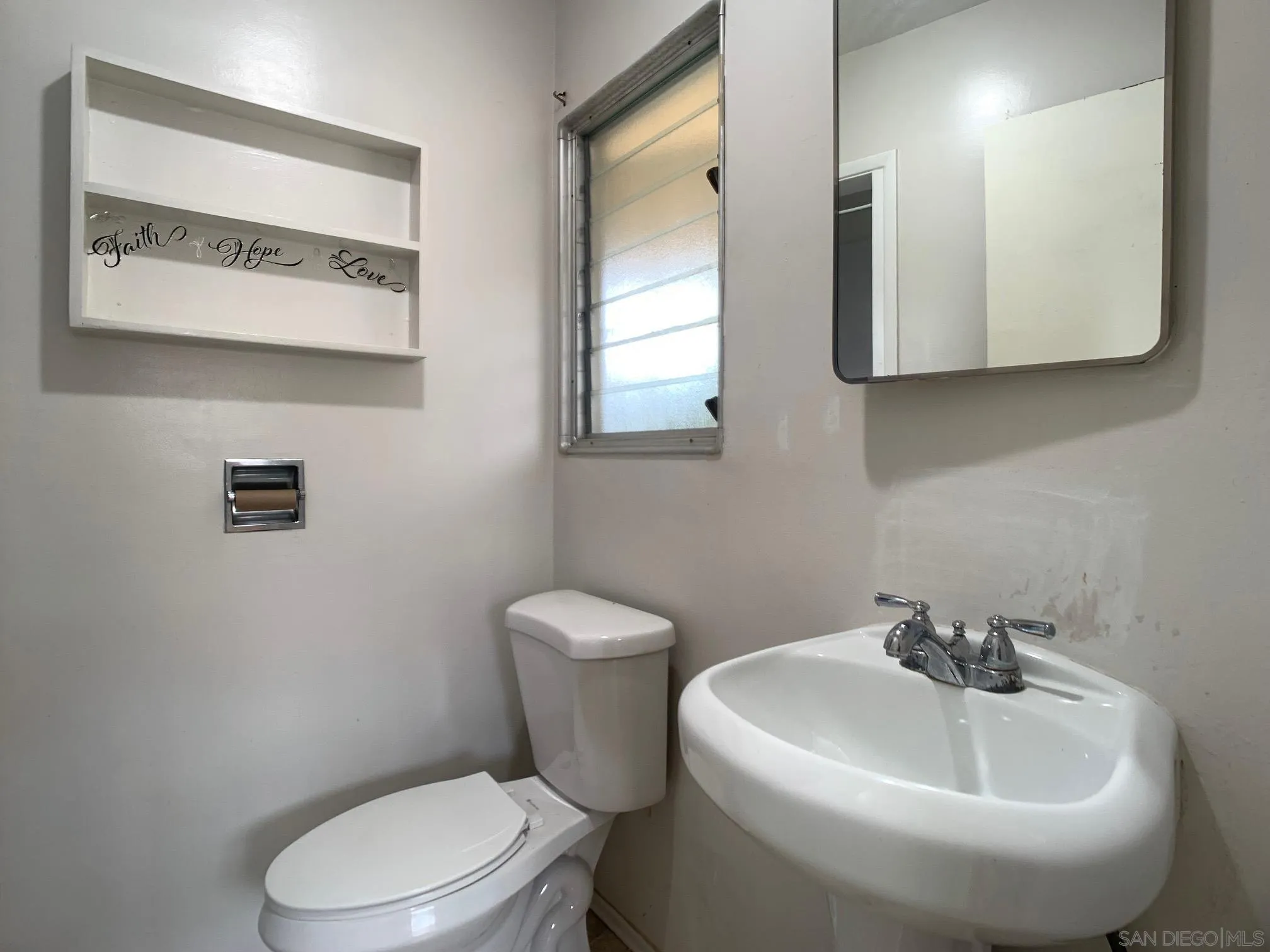 4240 Camino Paz La Mesa, CA 91941 - Photo 19 of 33 a white toilet sitting next to a bathroom sink
