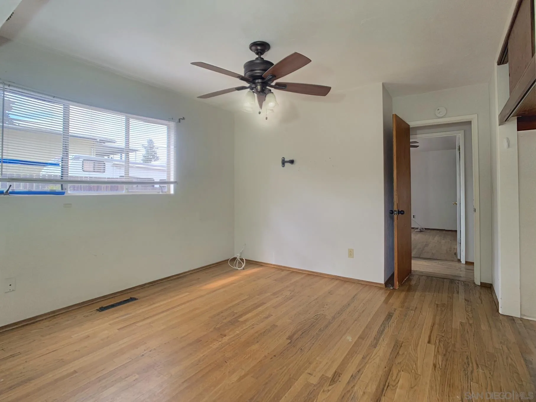 4240 Camino Paz La Mesa, CA 91941 - Photo 22 of 33 a view of empty room with wooden floor and fan