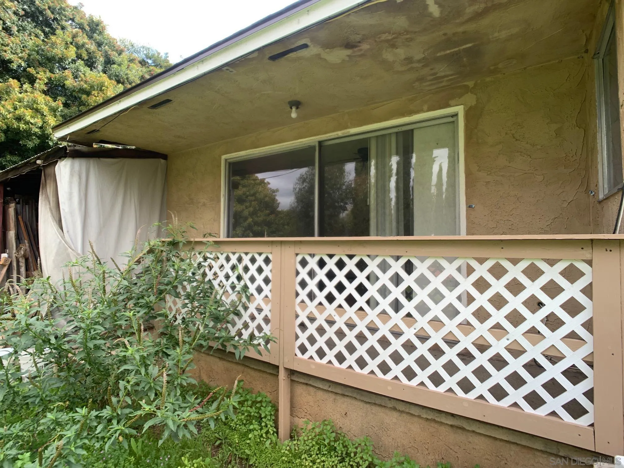 4240 Camino Paz La Mesa, CA 91941 - Photo 30 of 33 a black and white wall with wooden fence and the plants