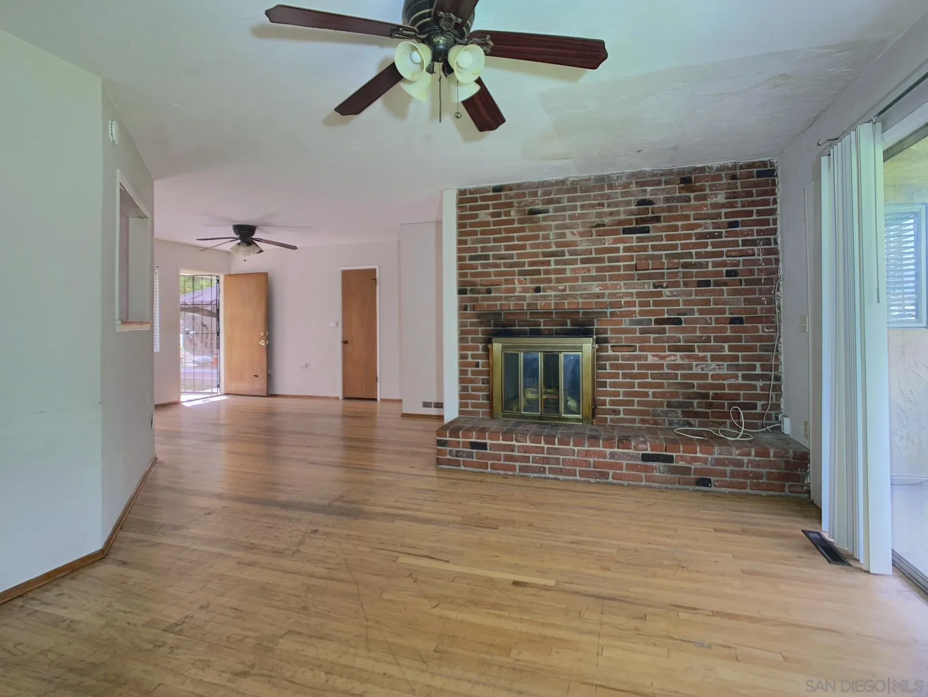 4240 Camino Paz La Mesa, CA 91941 - Photo 4 of 33 a view of an empty room with a fireplace and a window