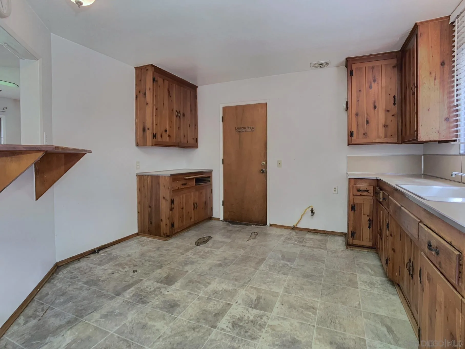 4240 Camino Paz La Mesa, CA 91941 - Photo 10 of 33 a view of an empty room with window and cabinet
