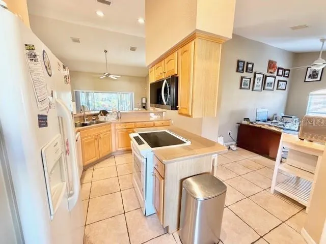a kitchen with a stove a refrigerator and a sink
