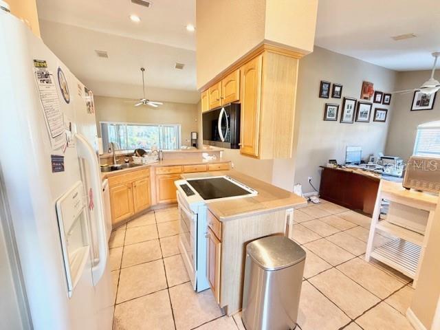 319 Green Reed Road DeBary, FL 32713 - Photo 7 of 21 a kitchen with a stove a refrigerator and a sink