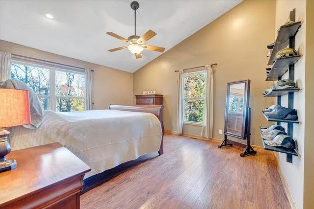 a view of a livingroom with wooden floor and furniture