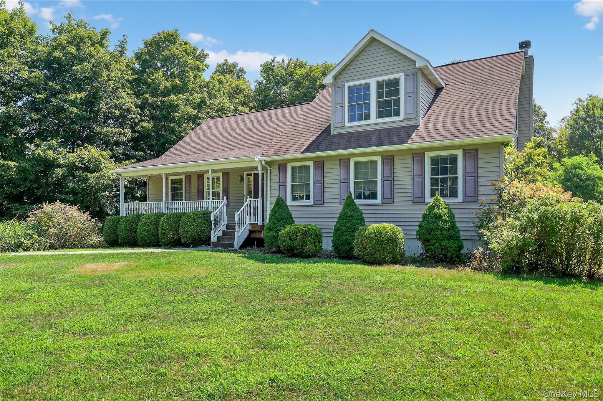 20 Seaman Road Circleville, NY 10919 - Photo 1 of 1 View of front of house featuring a porch, a front lawn, roof with shingles, and a chimney