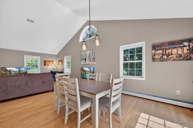 a dining room with wooden floor and breakfast area