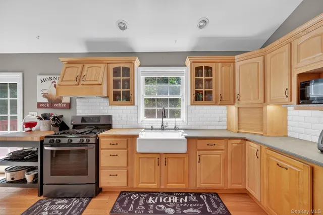 a kitchen with stainless steel appliances granite countertop a sink refrigerator and microwave