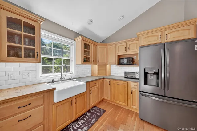 a kitchen with a stove a sink and a microwave