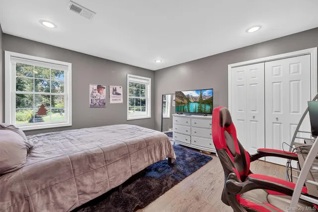 a bathroom with a double vanity sink mirror and toilet