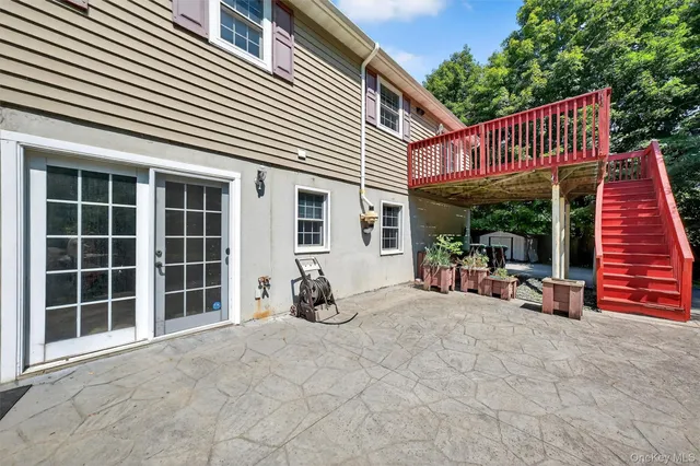 a balcony view with a large window and wooden floor