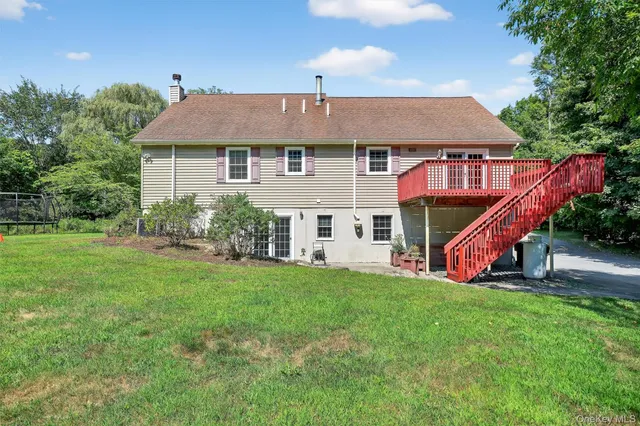 a view of a house with backyard and sitting area