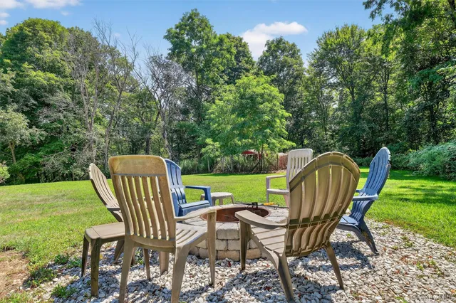 a view of a chairs in backyard of the house