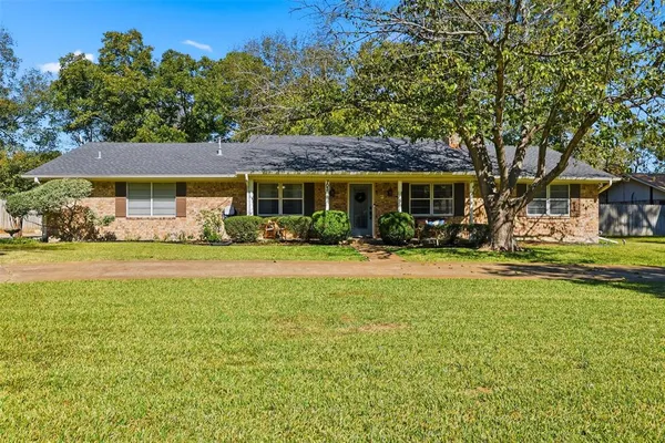 a front view of a building with a garden