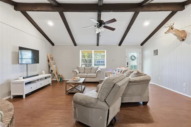 a large white kitchen with a sink and dishwasher