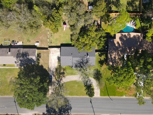 an aerial view of a residential houses with outdoor space